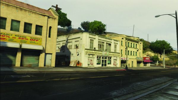 A low rise commercial street in Los Santos under daylight