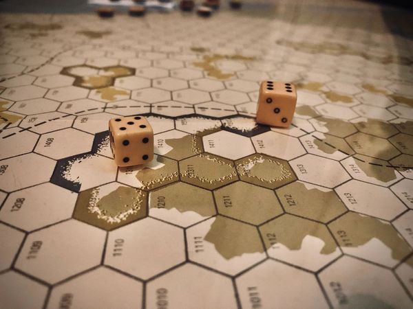 Two dice resting on the pale hex map of The Campaign for North Africa
