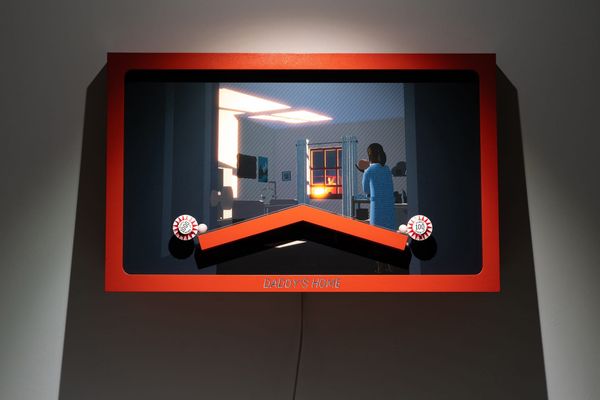 A red shadowbox pinball sculpture with an inverted V track over an illustrated nursery scene, a woman at the window with a baby