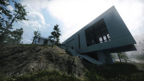 A white modernist house cantilevered over a grassy hillside under a cloudy sky.
