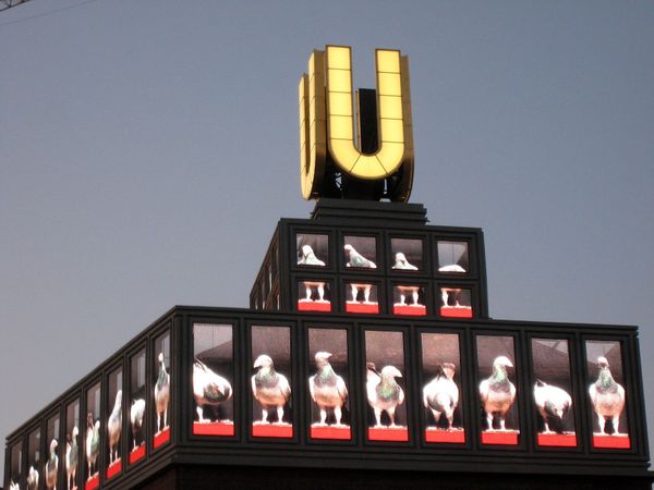 The Dortmunder U tower at dusk with video art playing on its rooftop screens