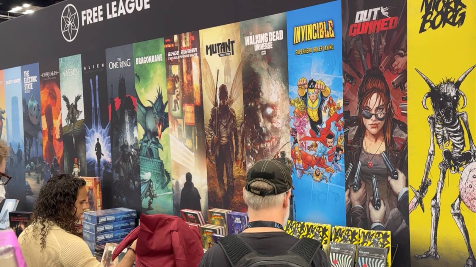 The Free League booth, with posters of the games they produce and distribute.