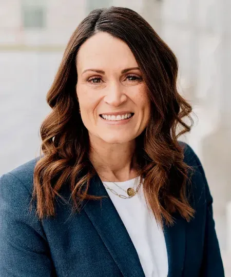 Tara Rosander smiling in a dark blazer over a white top.