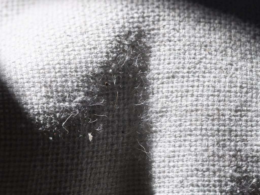 Close-up of white cotton pillowcase fabric texture