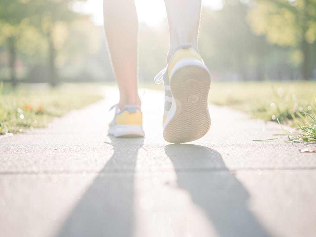 A person's feet during a gentle walk in a sunny park.