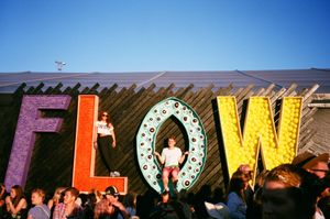group of people gathering near frees standing flow letters