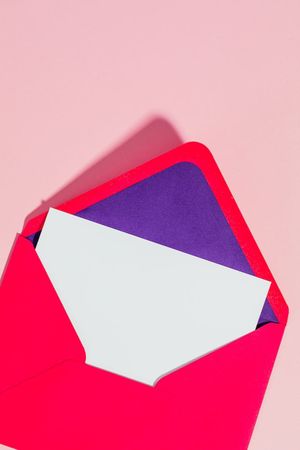 open envelope on pink studio background