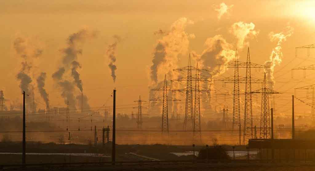engineering problems pollution: sky above the factory covered in yellow smog