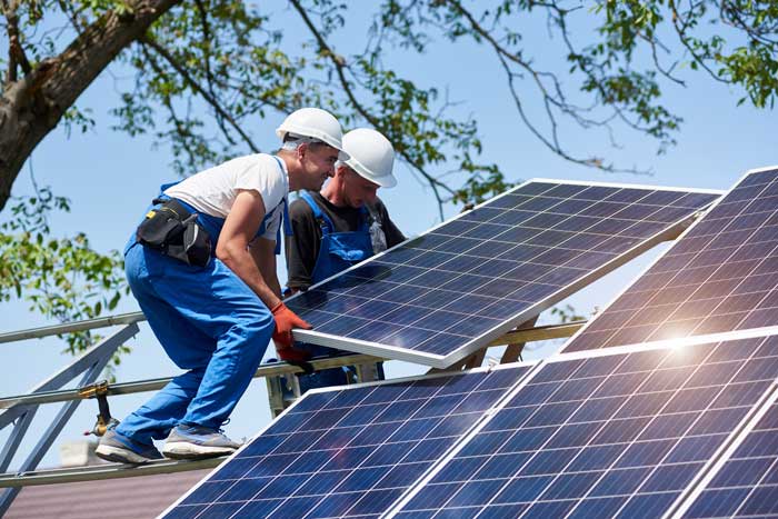 two men installing solar panels
