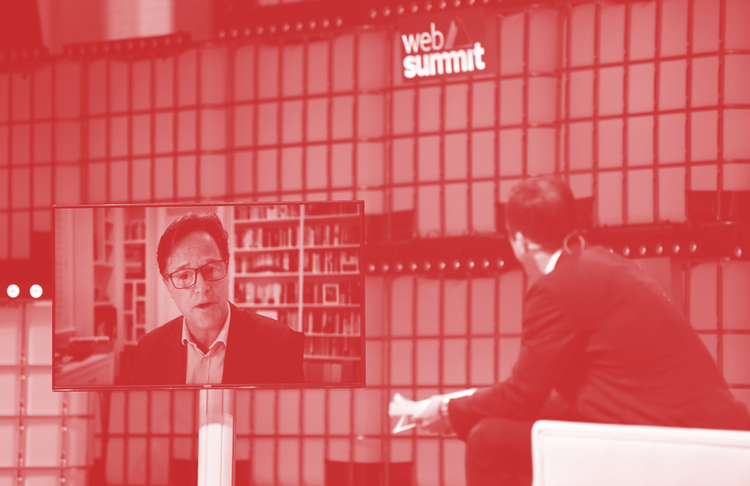 Nick Clegg, VP of Global Affairs & Communications, talking on screen, left, to a man on stage at Web Summit 2021 