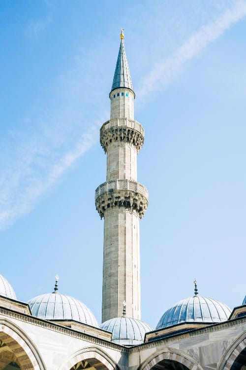 A mosque's minaret reaches towards the sky.