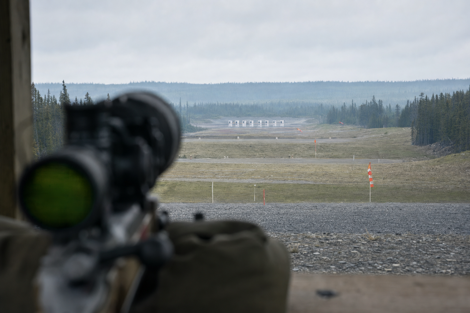 A Canadian F-Class style firing line with long-range sightline, mirage, wind markers, and target backers.