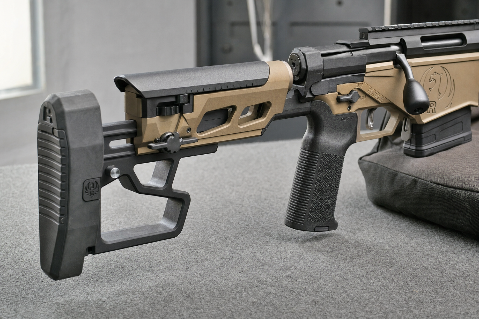 Close side view of a current Ruger Precision Rifle stock, showing the black cheekpiece, buttpad and bronze adjustment assembly.