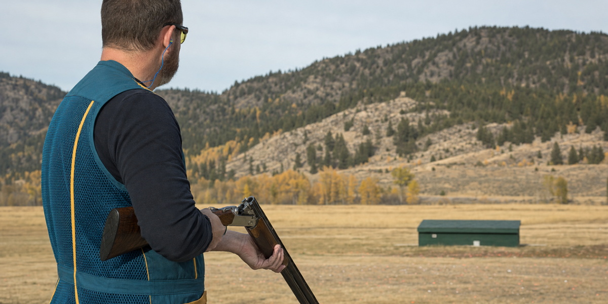 Illustrative trap participant with open shotgun.
