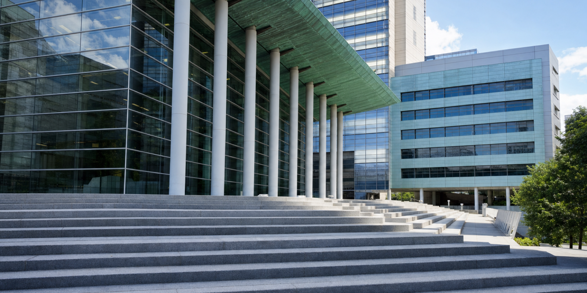 The Seattle federal courthouse with a copper-green canopy, pale columns and broad stone steps.