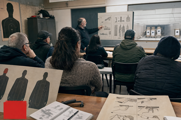 Editorial image of a Canadian firearms safety course classroom with adult students and course materials.