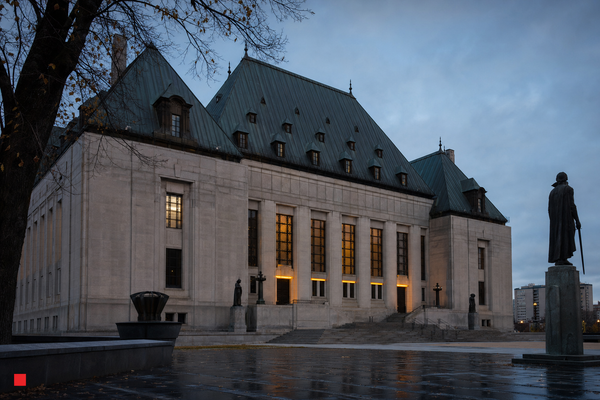 The Supreme Court of Canada building in Ottawa beneath a blue-grey sky.