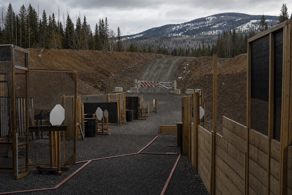 A northern B.C. action-shooting bay prepared for a national match, with a blocked on-ramp motif in the distance.