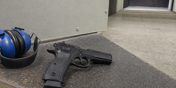 Illustrative generated photograph of a representative handgun resting on an indoor shooting-club bench.