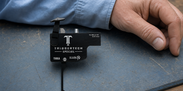 Generated photograph of an intact TriggerTech Tikka Special assembly on a worn mat, with a reader’s hand resting separately.