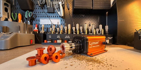 Lyman Brass Smith Case Trim Xpress on Steve's loading bench with numbered orange bushings and brass shavings in front.