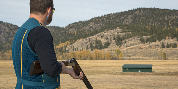 Illustrative trap participant with open shotgun.
