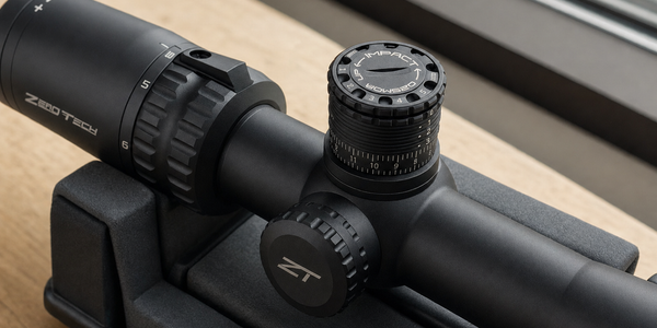 Close view of a black scope’s top selector, numbered reference markers and underlying elevation scale.