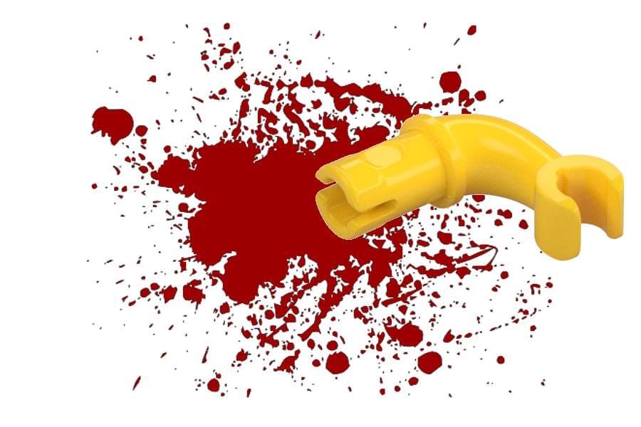 A dismantled lego arm on a red splatter.