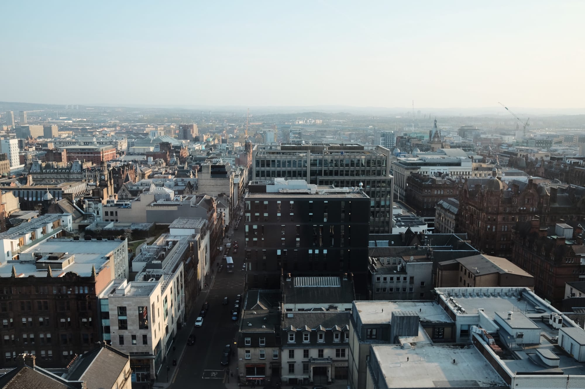 An aerial view of Glasgow, tall buildings stretching down to the river