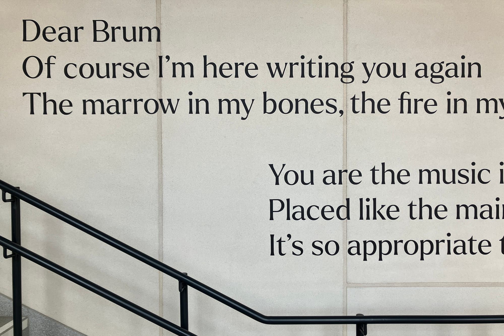 A poem about Birmingham on the wall at University Station is partially visible in the photo. It begins: "Dear Brum, of course I'm here writing you again..."
