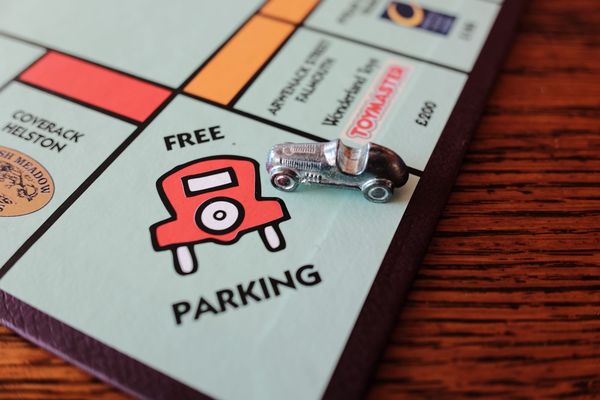 The free parking square on a Monopoly board with the racing car playing piece sitting on it.