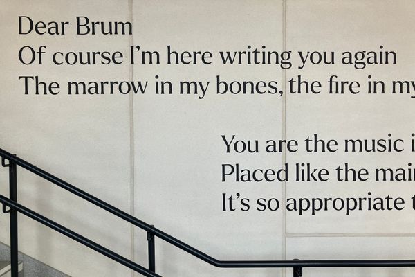 A poem about Birmingham on the wall at University Station is partially visible in the photo. It begins: "Dear Brum, of course I'm here writing you again..."