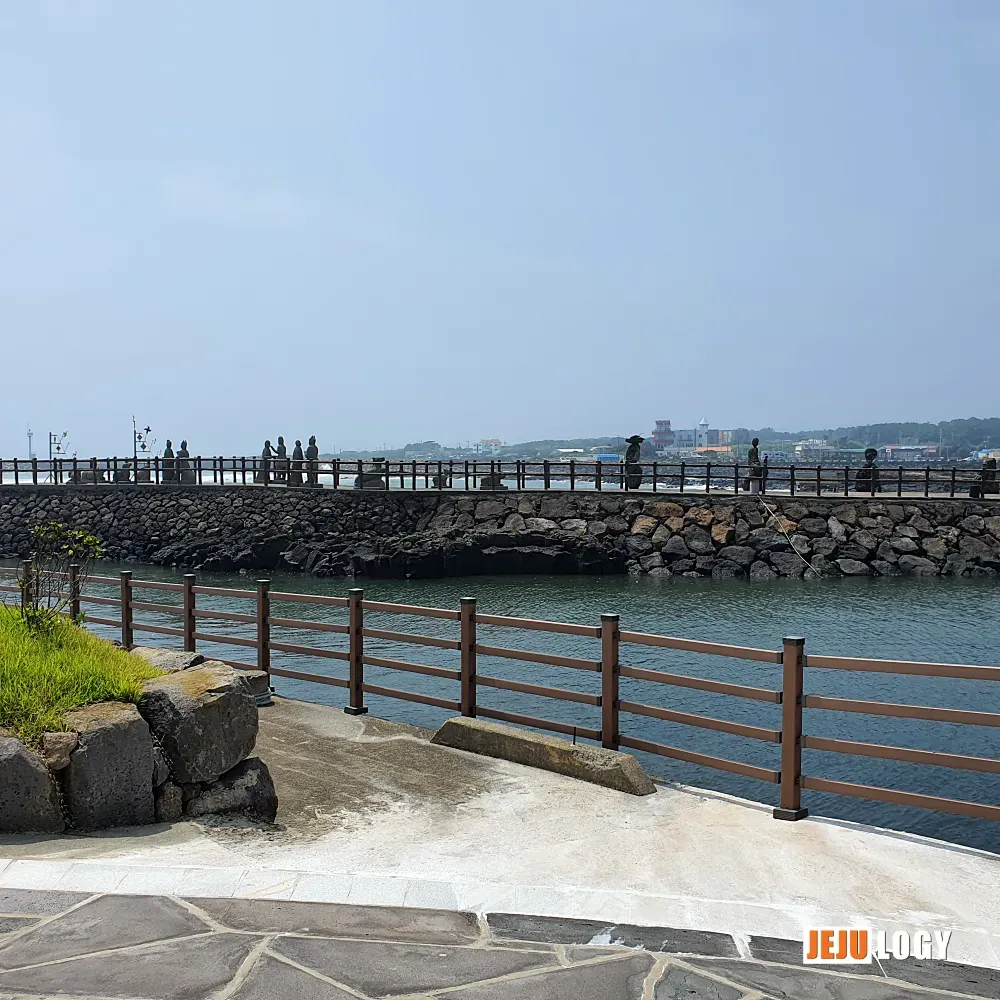 [3] A wooden walkway leads out across the harbor toward the breakwater. — webp_20200804_112357.webp