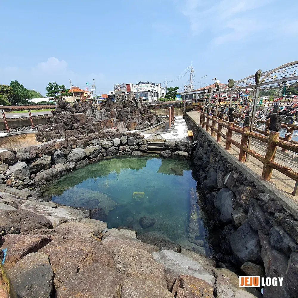 [9] A stone-walled tide pool by the port — once a practical fixture of village life, now a quiet pocket on the shore. — webp_20200804_113356.webp