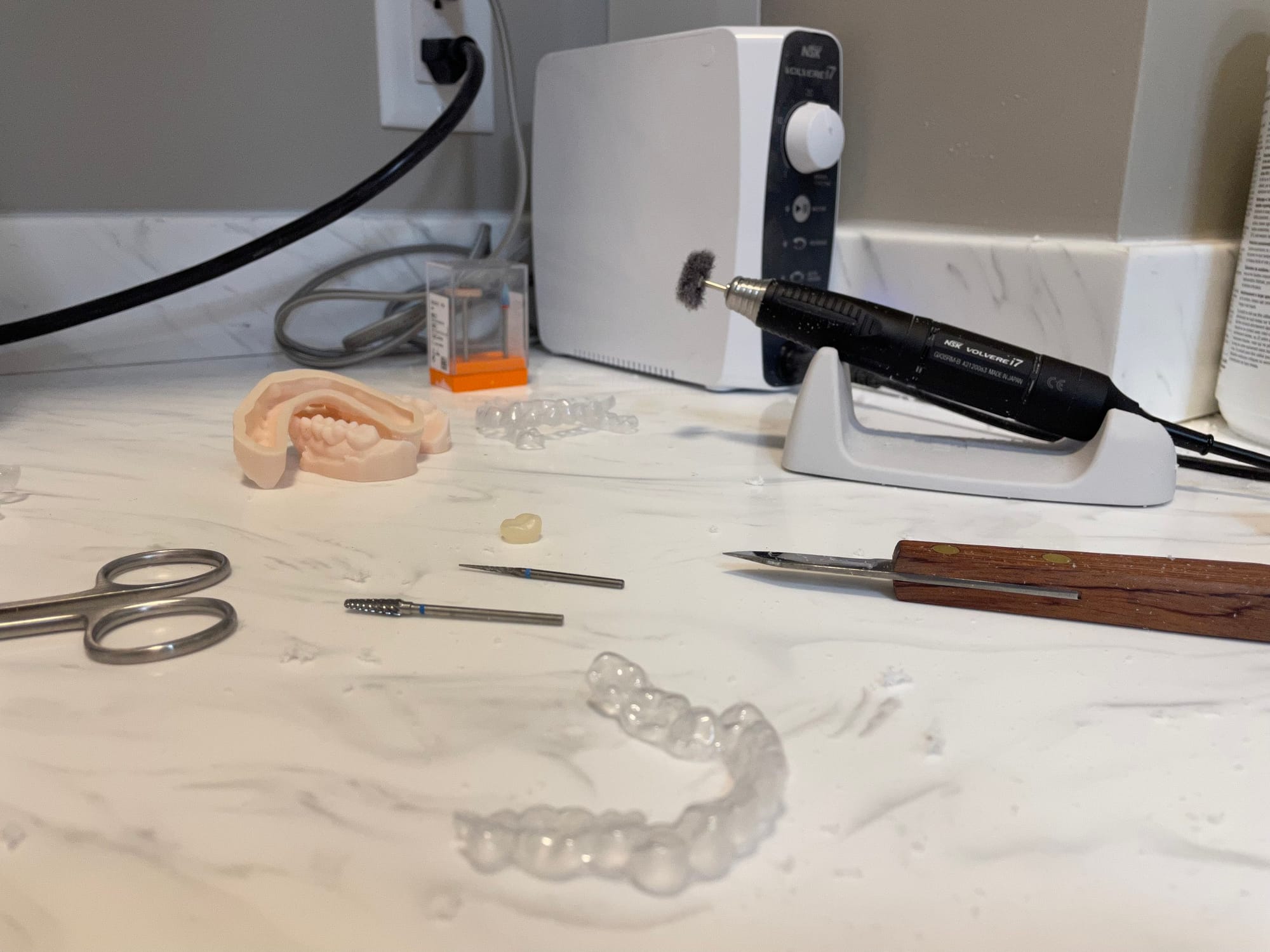 Model trimmer shaping printed dental models in the in-house lab