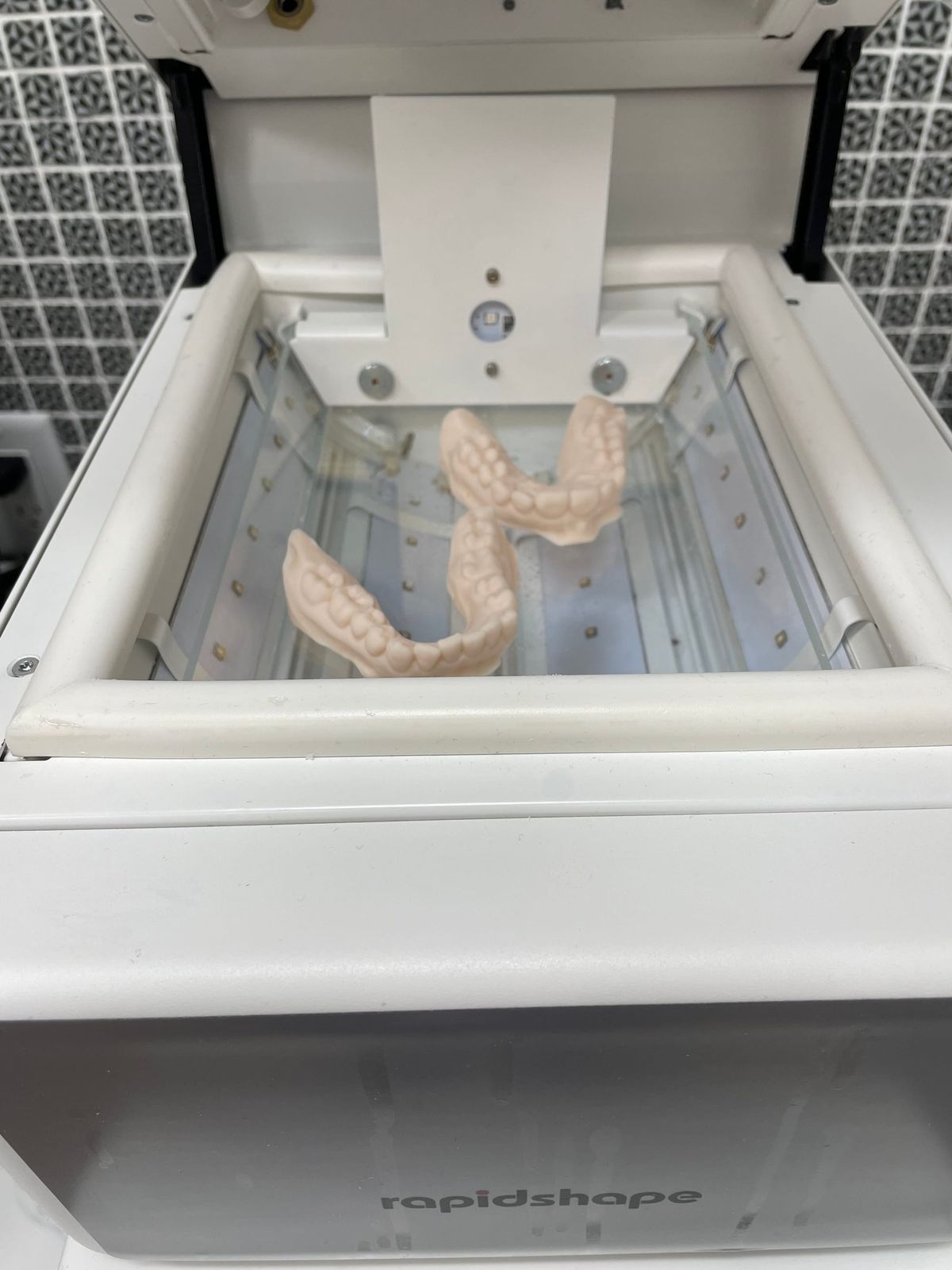 Clear aligner models curing under UV light in Longworth Dental's in-house lab