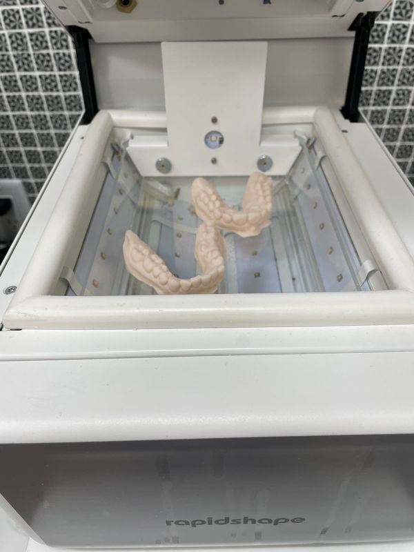 Clear aligner models curing under UV light in Longworth Dental's in-house lab