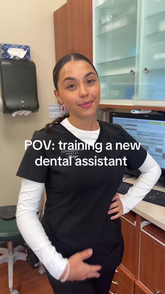 A Longworth Dental assistant in black scrubs at a Bowmanville operatory workstation, with on-screen text reading: POV: training a new dental assistant.