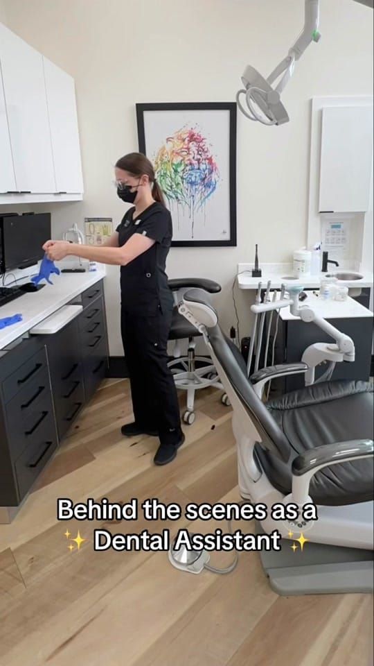 A masked Longworth Dental Courtice assistant working at a counter in an operatory, with on-screen text reading: behind the scenes as a Dental Assistant.