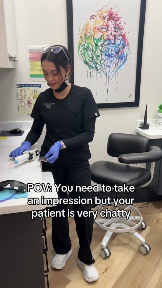 A Longworth Dental Courtice assistant preparing impression material at a counter, with on-screen text reading: POV: you need to take an impression but your patient is very chatty.