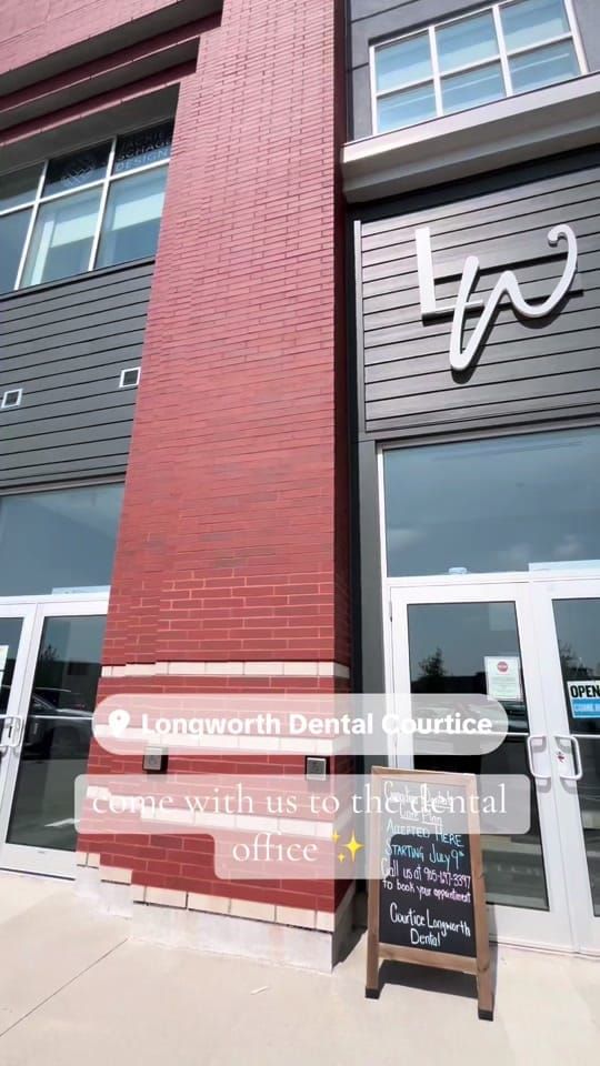 The red-brick exterior of Longworth Dental in Courtice with the LW sign and a new-patients sandwich board, with on-screen text reading: come with us to the dental office.