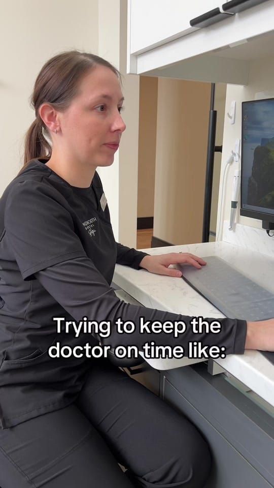 A Longworth Dental Courtice assistant at a computer and scanner station, with on-screen text reading: trying to keep the doctor on time like.