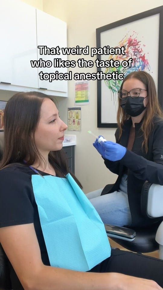 A masked Longworth Dental Courtice team member applies topical anesthetic on a swab for a patient reclined in the chair.