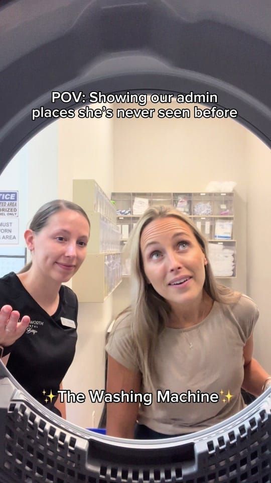 Two Longworth Dental Courtice team members peering into a washing machine at the start of a back-office tour.