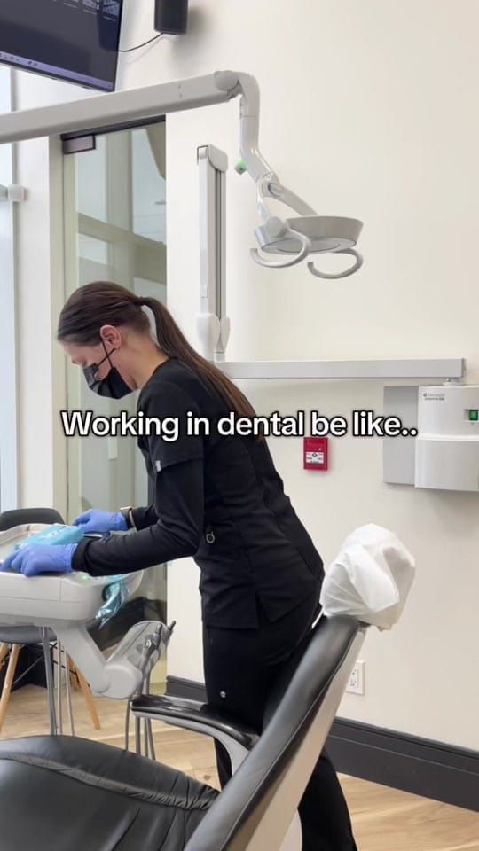 A Longworth Dental Courtice team member leaning over the chair with instruments, with on-screen text reading: working in dental be like.
