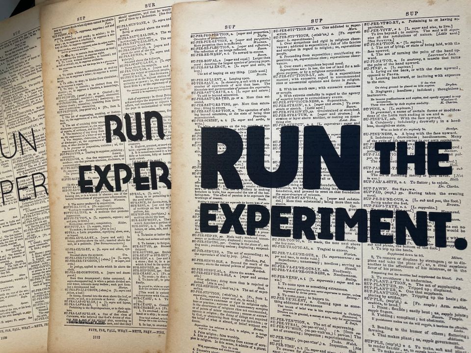 The words 'run the experiment' overprinted onto three different dictionary pages using three different fonts. 