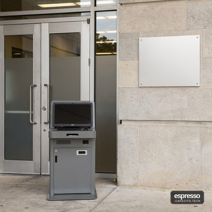 Empty office workspace with a desktop monitor showing a closed online permitting portal screen