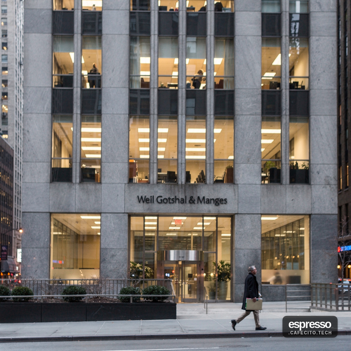 Empty office cubicles with packed boxes at a law firm being wound down