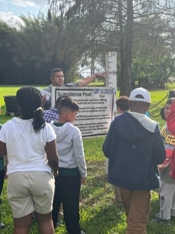 A group of people standing around a sign

AI-generated content may be incorrect.
