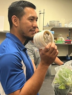 A person holding a plastic container

AI-generated content may be incorrect.